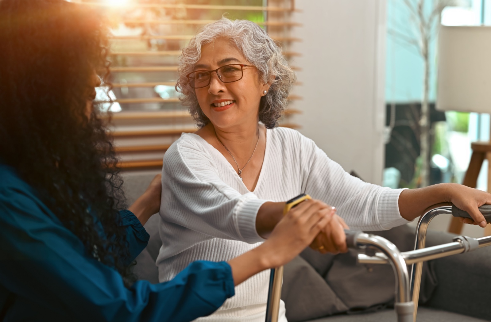 A rehabilitation staff member supports an older adult in the program.